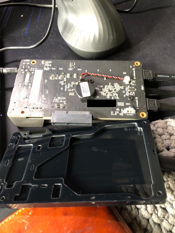 Installation of the caddy requires removing the stock backplate and splitting it.